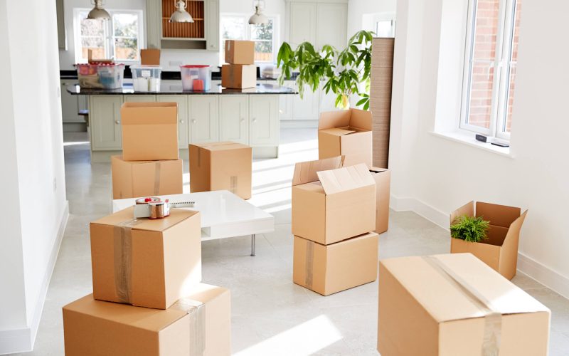 stacked-removal-boxes-in-empty-room-on-moving-day-RMYEDG3.jpg